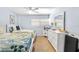 Light and airy bedroom with two beds, ceiling fan, and neutral decor at 6312 Midnight Pass Rd # 102S, Sarasota, FL 34242