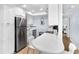 Bright kitchen featuring white cabinetry, stainless steel appliances, and breakfast bar at 6312 Midnight Pass Rd # 102S, Sarasota, FL 34242