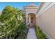 Welcoming front entrance with a covered porch, decorative columns, and manicured landscaping at 7419 Birds Eye Ter, Bradenton, FL 34203