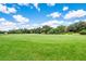 Expansive green golf course with clear blue skies, offering a scenic and enjoyable golfing experience at 7419 Birds Eye Ter, Bradenton, FL 34203