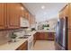 Well-lit kitchen showcasing wooden cabinets, tile backsplash, and modern appliances for a functional space at 7419 Birds Eye Ter, Bradenton, FL 34203