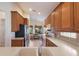 Spacious kitchen featuring wooden cabinets, stainless steel appliances, and a view into the breakfast nook at 7419 Birds Eye Ter, Bradenton, FL 34203