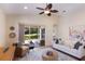 Open living space with tile floors, a ceiling fan, and access to the outdoor patio area at 7419 Birds Eye Ter, Bradenton, FL 34203