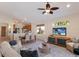 Spacious living area with a view of the kitchen, and access to the outdoor patio space at 7419 Birds Eye Ter, Bradenton, FL 34203