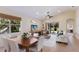 Open-concept living room with a high ceiling, tile flooring, and sliding glass doors to the patio at 7419 Birds Eye Ter, Bradenton, FL 34203