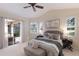 Bright main bedroom with a door to the outside, ceiling fan and coordinated decor offers a peaceful retreat at 7419 Birds Eye Ter, Bradenton, FL 34203
