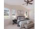Serene main bedroom featuring a comfortable bed, soft lighting, and windows with plantation shutters at 7419 Birds Eye Ter, Bradenton, FL 34203