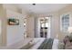 Main bedroom leading to the outdoors, and featuring neutral decor and plenty of natural light at 7419 Birds Eye Ter, Bradenton, FL 34203