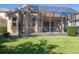 Inviting screened patio with ample space for outdoor seating, perfect for enjoying the serene backyard and sunshine at 7419 Birds Eye Ter, Bradenton, FL 34203