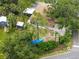 Aerial view of a home surrounded by lush greenery and a storage shed in the back at 760 Azure Rd, Venice, FL 34293