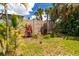 Backyard featuring lush tropical landscaping and a serene green space, offering a private retreat at 760 Azure Rd, Venice, FL 34293