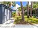 Private backyard featuring an outdoor storage shed, luscious trees, and sidewalk access at 760 Azure Rd, Venice, FL 34293
