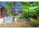 Lush backyard featuring tropical foliage, raised garden beds, and a serene outdoor space at 760 Azure Rd, Venice, FL 34293