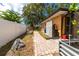 Landscaped backyard with a paver pathway, garden beds and a white privacy fence at 760 Azure Rd, Venice, FL 34293