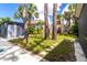A tranquil backyard retreat with lush trees, a shed, and a stone pathway at 760 Azure Rd, Venice, FL 34293