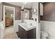 Bathroom featuring a double sink vanity and decorative textured walls at 760 Azure Rd, Venice, FL 34293
