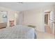 Comfortable bedroom with neutral walls, a seating area, and access to the en suite at 760 Azure Rd, Venice, FL 34293