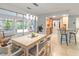 A sunlit dining area adjacent to the screened lanai and open to the modern kitchen at 760 Azure Rd, Venice, FL 34293
