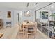 Cozy dining area featuring a wooden table, modern chairs, and elegant pendant lighting at 760 Azure Rd, Venice, FL 34293