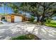 Charming home with a gravel driveway, attached two-car garage, and a well manicured lawn at 760 Azure Rd, Venice, FL 34293
