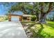 Charming single-story home with a well-maintained lawn and a large, mature tree in the front yard at 760 Azure Rd, Venice, FL 34293