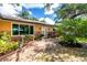 Charming home featuring a brick walkway, lush landscaping, and a welcoming entrance at 760 Azure Rd, Venice, FL 34293