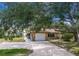Charming single-story home with a well-manicured lawn and long concrete driveway at 760 Azure Rd, Venice, FL 34293
