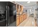 Modern kitchen featuring wood cabinets, granite countertops, and stainless steel appliances at 760 Azure Rd, Venice, FL 34293