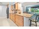 Modern kitchen featuring stainless steel appliances, granite countertops, and barstool seating at 760 Azure Rd, Venice, FL 34293