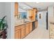 Well-lit kitchen featuring wooden cabinets, granite countertops, and stainless steel appliances at 760 Azure Rd, Venice, FL 34293
