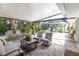 Relax and unwind in the enclosed lanai with brick pavers, comfortable seating, and tropical views at 760 Azure Rd, Venice, FL 34293