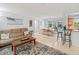 A comfortable living area flows from the dining room and into the kitchen with barstool seating at 760 Azure Rd, Venice, FL 34293