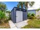 Backyard storage shed with a sliding barn door and ample natural light at 760 Azure Rd, Venice, FL 34293