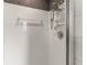 Tiled shower with shower head, niche, and glass door at 760 Azure Rd, Venice, FL 34293
