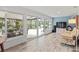 Relaxing sunroom with large windows, comfortable seating, and a view of the outdoor space at 760 Azure Rd, Venice, FL 34293