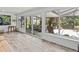 Bright sunroom with tiled floors and sliding glass doors leading to an outdoor living space at 760 Azure Rd, Venice, FL 34293