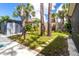 Landscaped backyard featuring green grass, sidewalk, and an outdoor storage shed at 760 Azure Rd, Venice, FL 34293