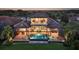 Beautiful aerial view of backyard with pool and lanai at dusk at 7665 Haddington Cv, Bradenton, FL 34202