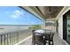Balcony area features table, chairs and fan and a view of the lake at 7665 Haddington Cv, Bradenton, FL 34202