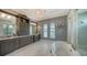 Double vanity bathroom featuring granite countertops, dark wood cabinets, marble floors, and windows at 7665 Haddington Cv, Bradenton, FL 34202