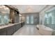 Luxurious bathroom featuring a soaking tub, double vanities, marble floors, and a glass shower at 7665 Haddington Cv, Bradenton, FL 34202