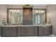 Double vanity bathroom featuring granite countertops, dark wood cabinets and marble floors at 7665 Haddington Cv, Bradenton, FL 34202