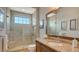 Bathroom features a walk in shower and a granite vanity at 7665 Haddington Cv, Bradenton, FL 34202