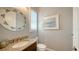 Powder room featuring granite counters, decorative mirror, and plantation shutters at 7665 Haddington Cv, Bradenton, FL 34202