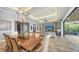 Open dining room with a wine storage and an outdoor lanai space on the other side at 7665 Haddington Cv, Bradenton, FL 34202
