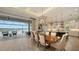Bright dining space with a large table, modern light fixtures, and access to a patio overlooking the waterfront, perfect for entertaining at 7665 Haddington Cv, Bradenton, FL 34202