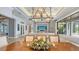 Open dining room with views to the outside and a living room with a TV on the wall at 7665 Haddington Cv, Bradenton, FL 34202