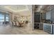 Elegant dining area featuring modern lighting, tile floors, access to the kitchen and water views, ideal for entertaining at 7665 Haddington Cv, Bradenton, FL 34202