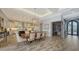 Elegant dining room with a large table, modern chandeliers, and an adjacent kitchen area, ideal for Gathering gatherings at 7665 Haddington Cv, Bradenton, FL 34202
