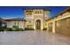 Charming exterior view showcasing lush landscaping and a well-maintained front yard with a large paver driveway at 7665 Haddington Cv, Bradenton, FL 34202
